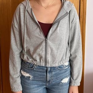 Grey zip up hoodie.